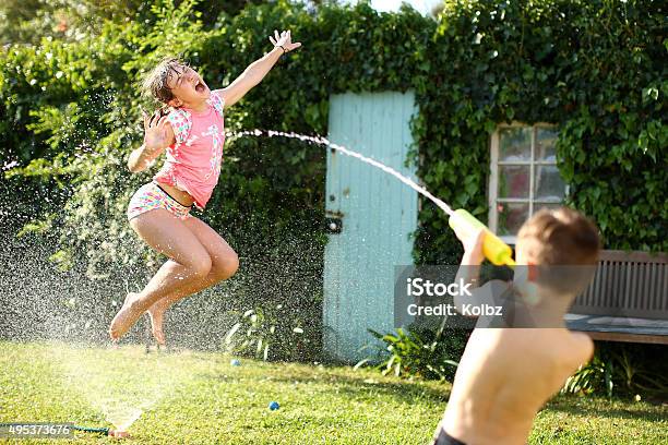 Water Fight Stock Photo - Download Image Now - Child, Water Fight, Sprinkler