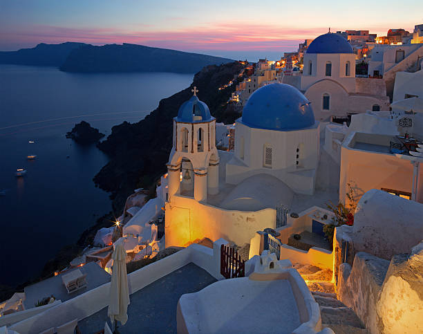 istock Santorini - typically blue churches cupolas in Oia at dusk 495374464