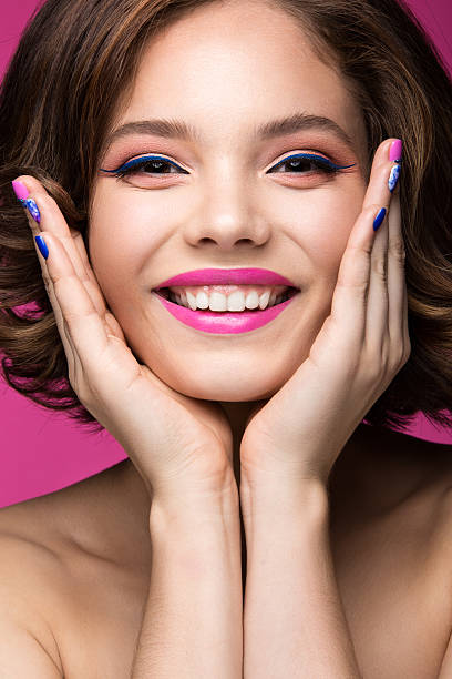 istock Beautiful model girl with bright pink makeup, smile and colored 495376330