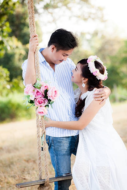 istock Young couple in love  sitting on swing 495377882