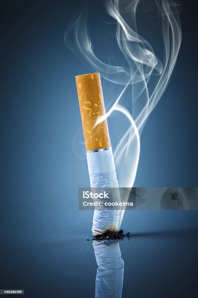 Cigarette butt - No smoking. No smoking. Cigarette butt on a blue background. Blue Stock Photo