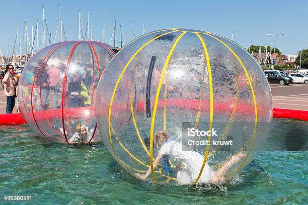 Children Have Fun Inside Plastic Balloons On The Water Stock Photo - Download Image Now