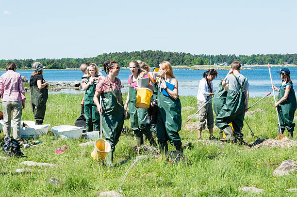 Girls in biology excursion Kalmar, Sweden - May  26: Female students on ecology, biology field trip to study marine life. field trip stock pictures, royalty-free photos & images