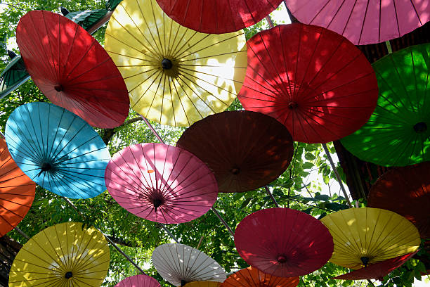 Traditional umbrellas and faechers from Paier are produced in a paper umbrella factory in Chiang Mai in the north of Thailand in South East Asia.