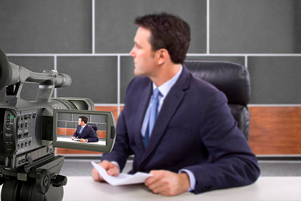istock Camera Filming a Reporter or Anchorman in a Studio 495385403