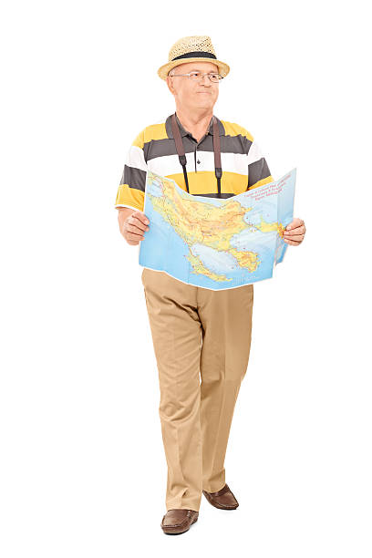 istock Mature tourist walking with map in his hands 495385635
