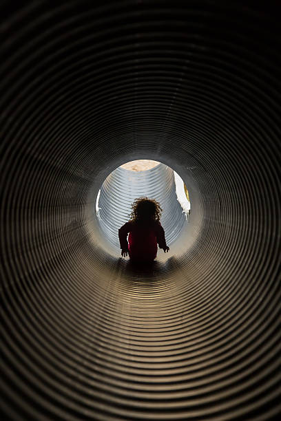 istock Girl Sliding Down Large Corrugated Slide 495387342