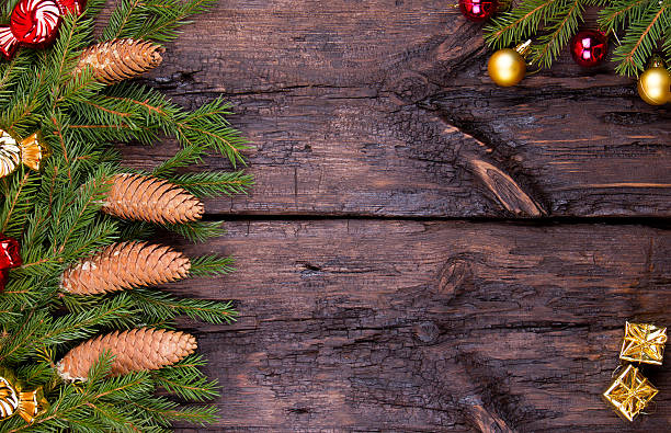 istock Fir cones, spheres and garlands on a wooden background 495388854