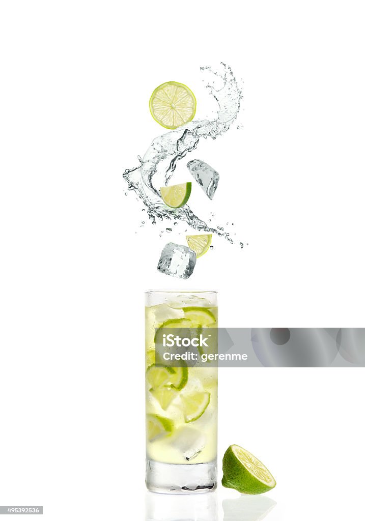 splash and cocktail splash,ice cubes and fruits coming into a glass of cocktail Splashing Stock Photo