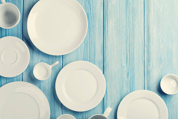 istock Empty plates and bowls on blue wooden background 495392580