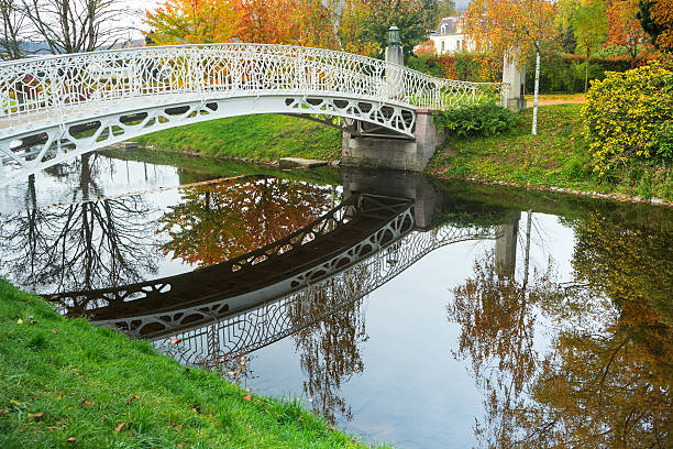 istock Beautiful autumn landscape with bridge and reflection in river 495393170
