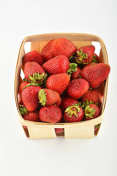 istock Mellow strawberries in wooden basket isolated on white 495394778