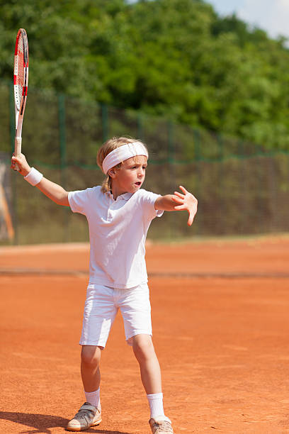 istock boy at tennis lesson 495414428