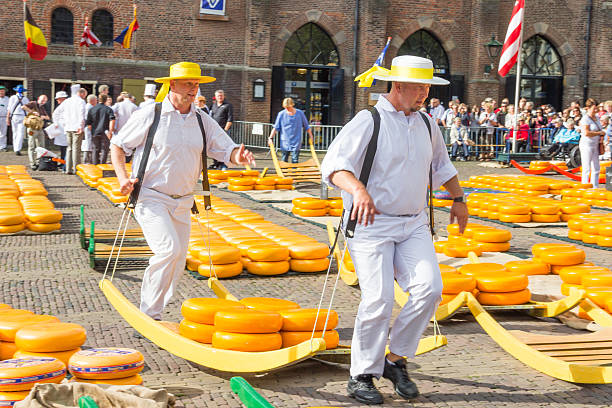 Alkmaar, The Netherlands - September 7 2012: Carriers walking with cheese at a famous Dutch cheese market.