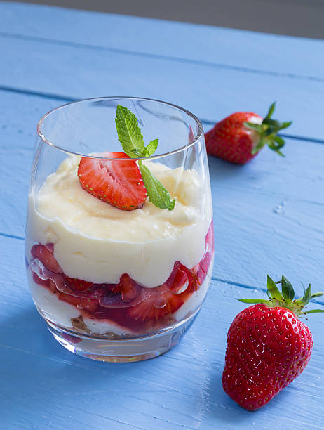 istock Vanilla pudding with tipsy strawberries on wood 495415309