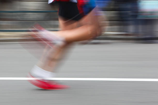 istock Marathon runner legs closeup - motion blur. 495415381