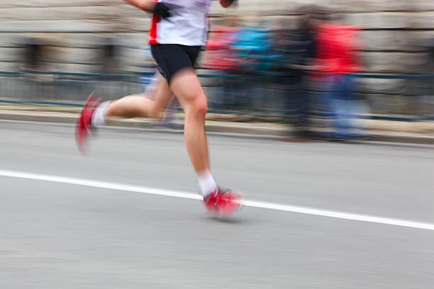 istock Marathon runner legs closeup - motion blur. 495415383