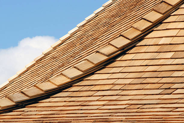 Cedar Shingles New cedar shingles on roof - blue sky and cloud in background cedar stock pictures, royalty-free photos & images