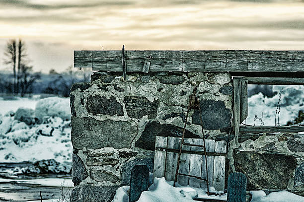 Abandoned Barn Old wagon leaning against remnants of an old barn covered wagon horse cart snow winter stock pictures, royalty-free photos & images