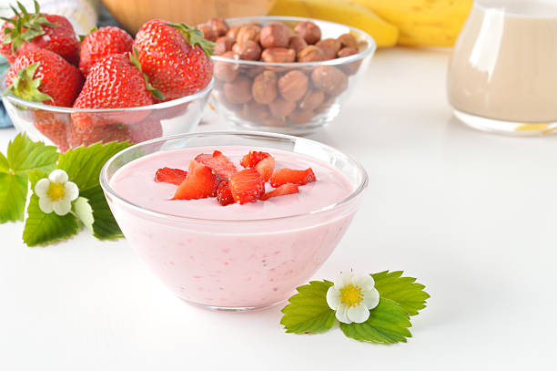 istock Delicious strawberry yogurt on white table. 495416949