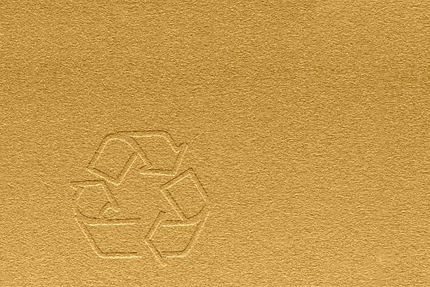 Recycling symbol on brown craft paper texture or background. Top view.