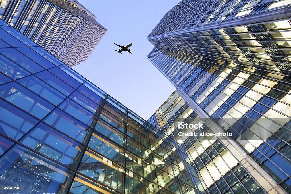 Jet airplane take off Office building, London City, England, UK Canon Eos 5d mark2, lens 17-40 L at Canary Wharf, London, UK. Airplane Stock Photo