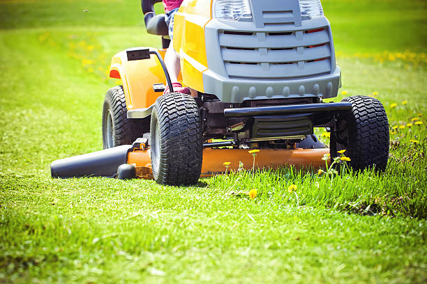 Lawn mower Closeup of mower cutting the grass garden tractor stock pictures, royalty-free photos & images