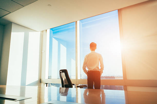 istock Businessman standing looking out of the window 495419868