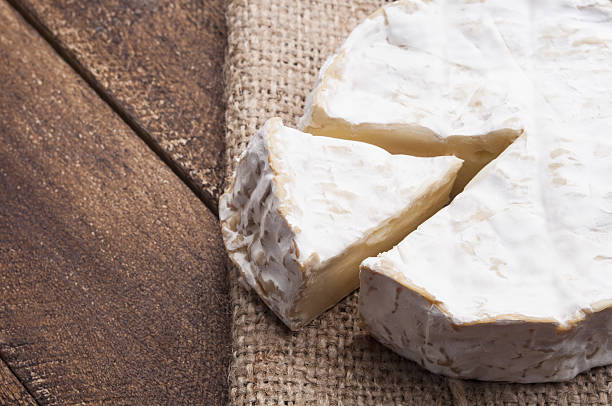 istock Camembert cheese on a wooden board 495420179
