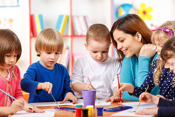 istock Group Of Elementary Age Children In Art Class With Teacher 495420503