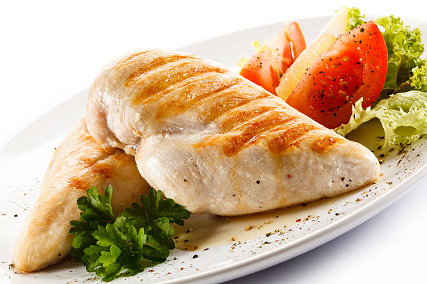 istock Roast chicken fillets and vegetables on white background 495420522