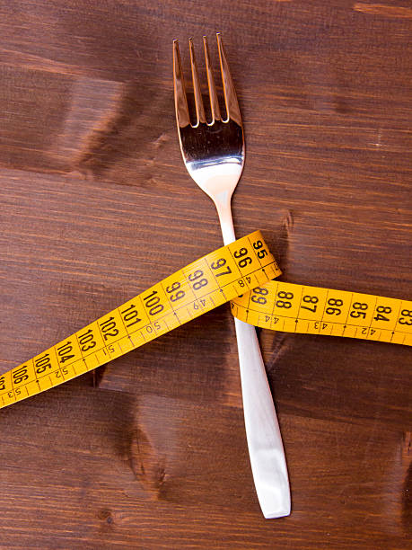 istock Fork with tape measure on wood 495420532