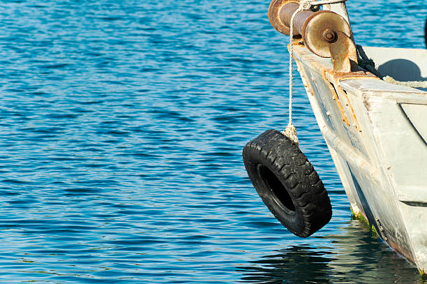 Old concrete pier, mooring berth with car tires for mooring boats and yachts. Winter pier, old part of the city of Kronstadt, St. Petersburg, Russia