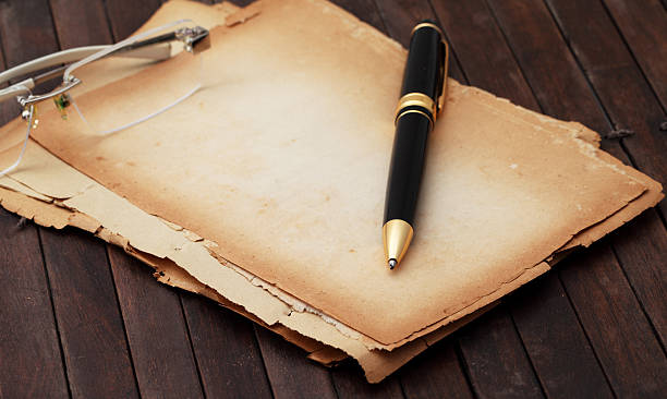 istock vintage notebook old papers and pens on a wooden table 495421467
