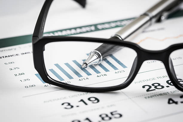 istock closeup glasses on financial report 495422227