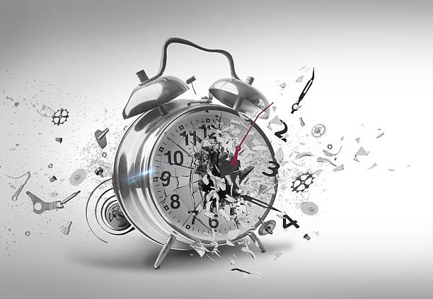 Smashing Alarm clock An alarm clock being destroyed with bits of its internal parts being scattered all over the place. broken spring stock pictures, royalty-free photos & images