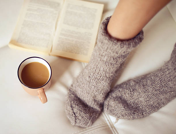 istock female legs in woolen socks close up 495436754