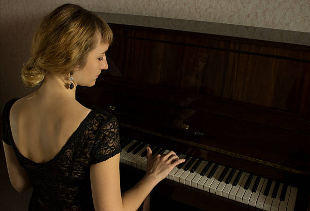 istock Young beautiful girl playing on the piano 495436768