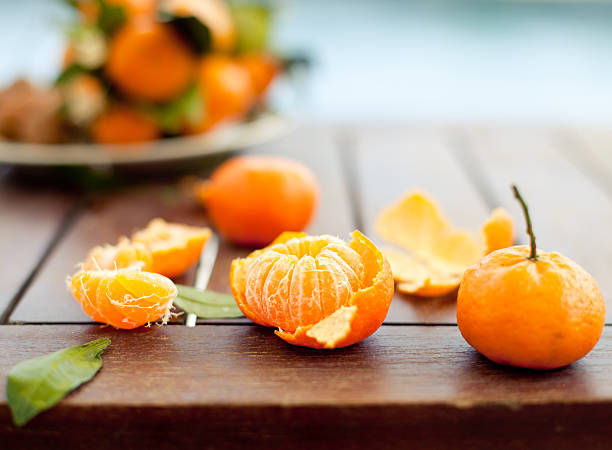istock Fresh tangerines on a wooden table blue, sea, water background 495437832