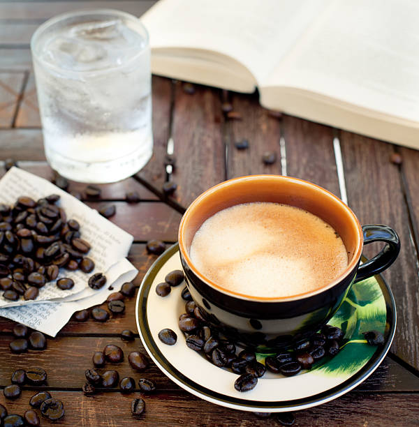 istock Cup of coffee, cappuccino with beans and a book. 495437990