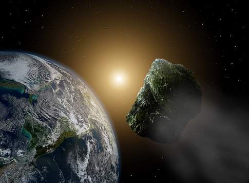 Asteroide en el espacio cerca de tierra en la luz del sol photo