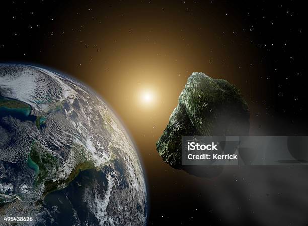 Asteroid In Space Near Earth In Sunlight Stock Photo - Download Image Now - Asteroid, Meteorite, Meteor