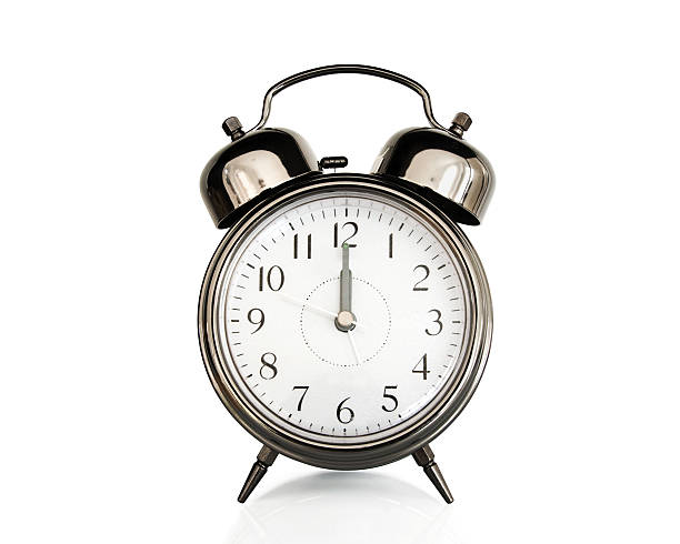 istock Twelve on an old vintage alarm clock isolated on white 495439190