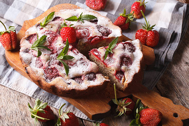 istock homemade rustic strawberry pie with mint on a cutting board 495439230
