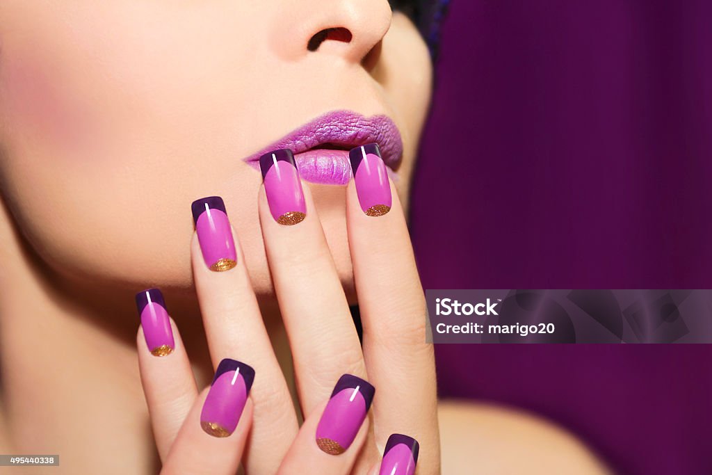 Lilac French manicure. Lilac French manicure for a young woman with purple lips. Fingernail Stock Photo