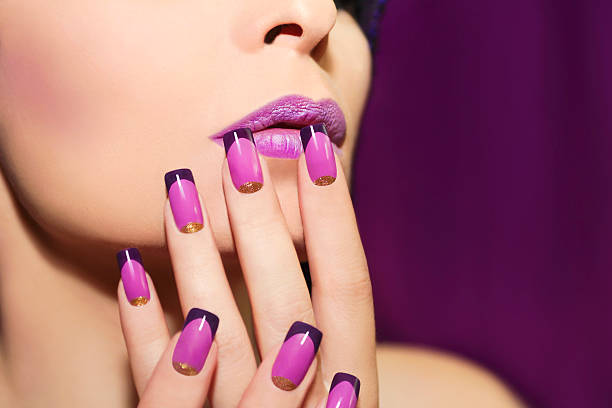Lilac French manicure. Lilac French manicure for a young woman with purple lips. fingernail photos stock pictures, royalty-free photos & images