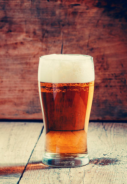 istock large glass of light beer with foam 495441936