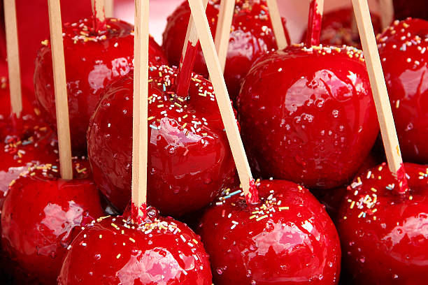 Delicious candy apples covered with colorful sprinkles Sweet red candy apples covered with colorful sprinkles. candied fruit stock pictures, royalty-free photos & images