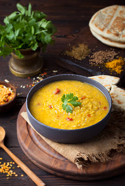 Red lentil Indian soup with flat bread. Masoor dal. stock photo