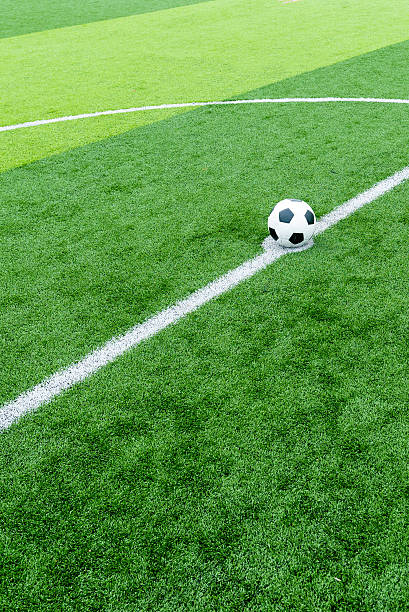 istock soccer field grass with ball at kick off point. 495456342
